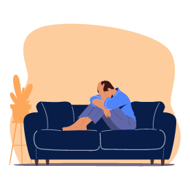Une homme se tient la tête sur son canapé
